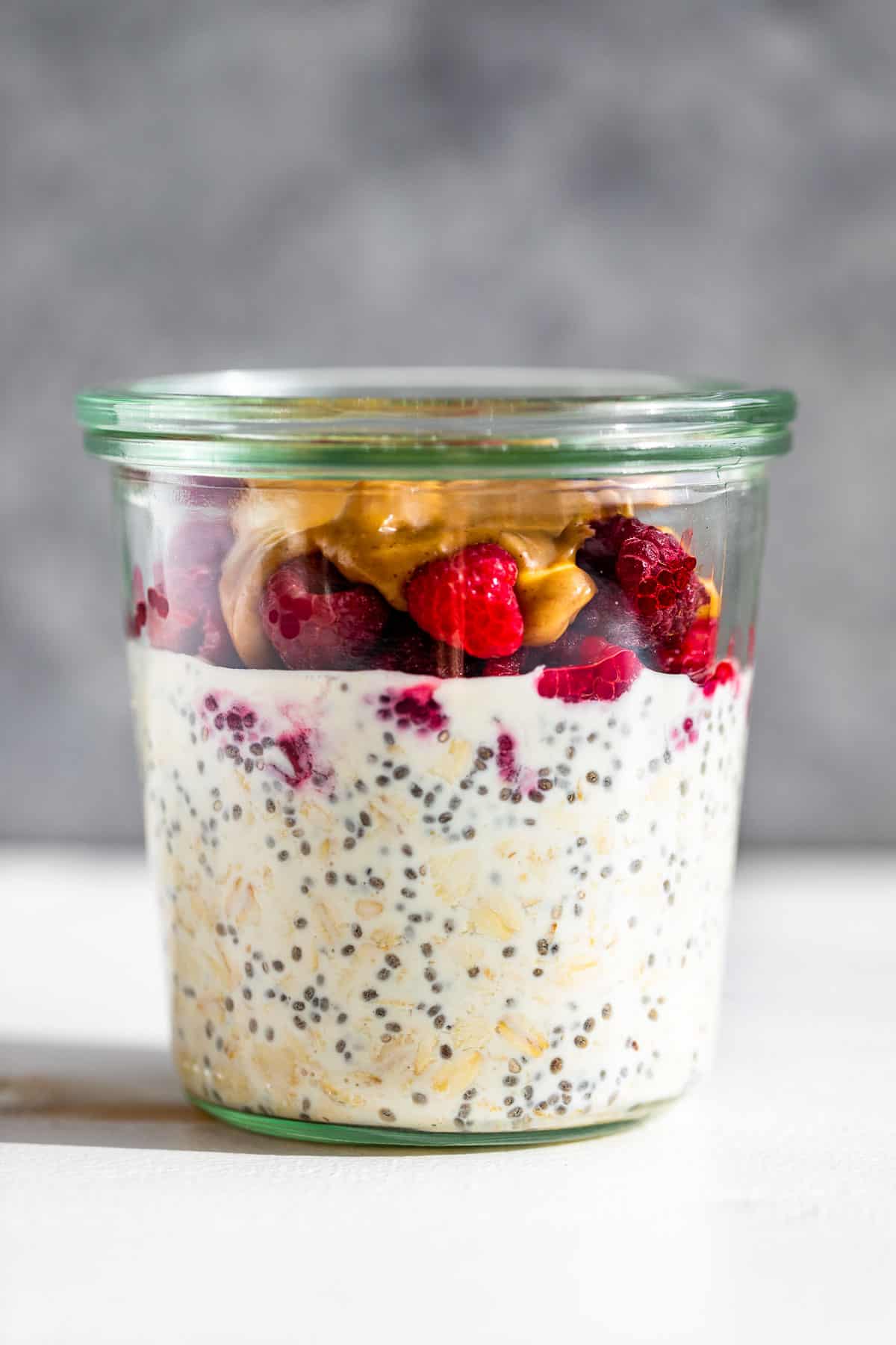 Peanut Butter and Jelly Overnight Oats on a white background.