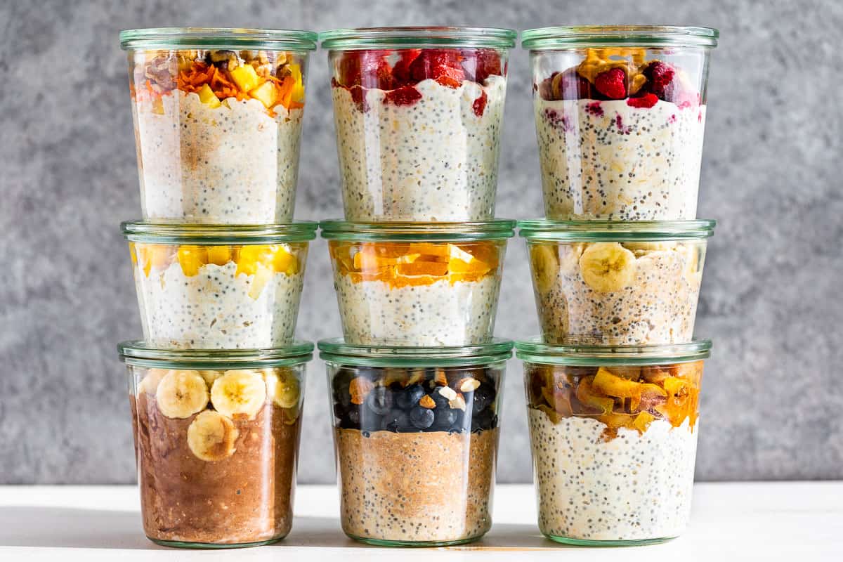 Nine of the 10 overnight oats in clear glass jars.