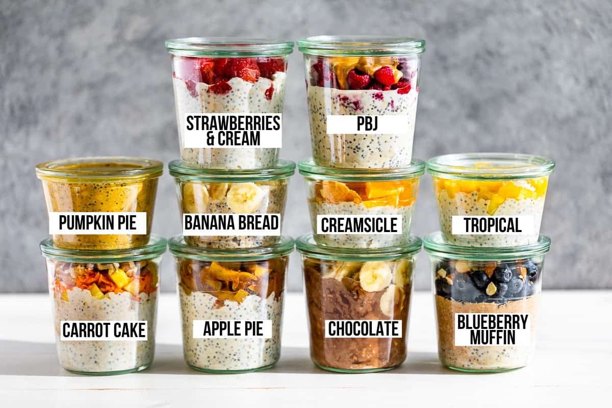 All ten flavors of overnight oats in 10 clear glass jars on a white background.