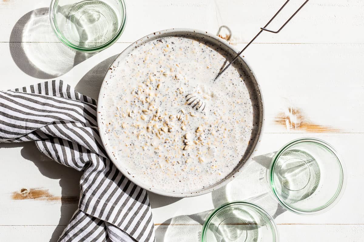 Large batch of overnight oats being mixed together in a large bowl.