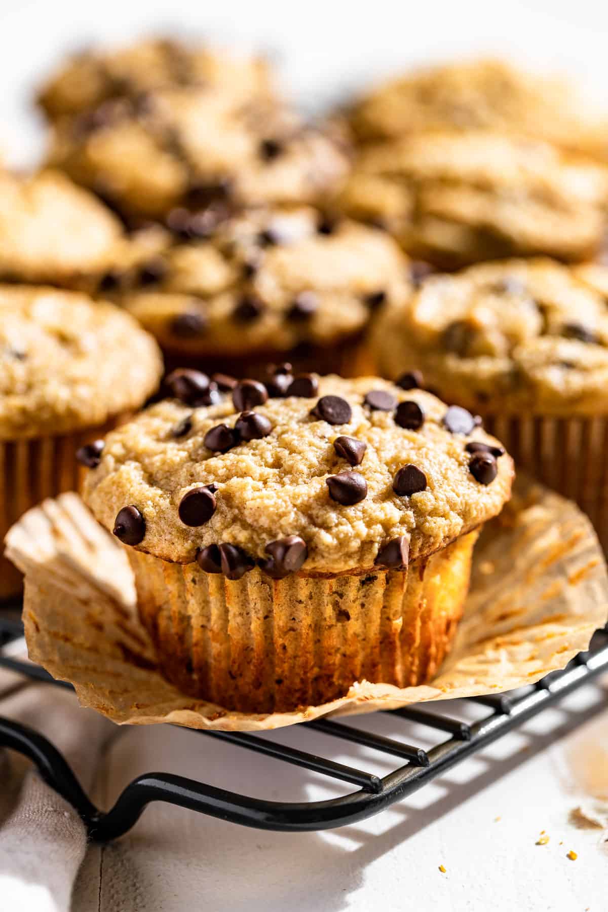 Side view of Paleo Banana Muffins sitting on a wire cooling rack.