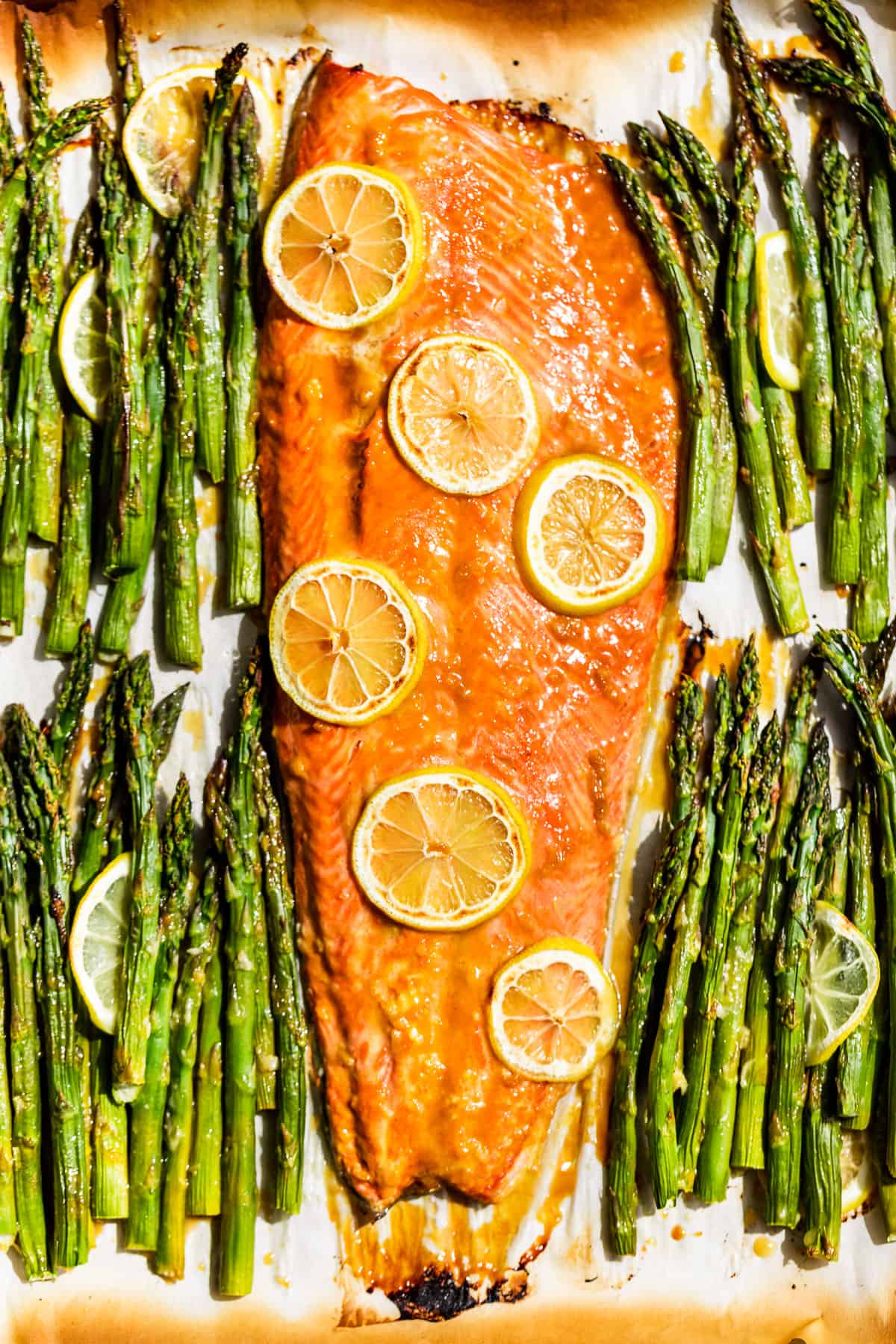 Straight down view of honey mustard roasted salmon with asparagus on the side.