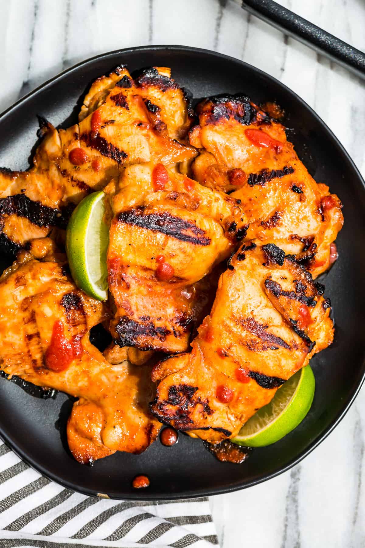 Honey Sriracha Grilled Chicken on a black plate.