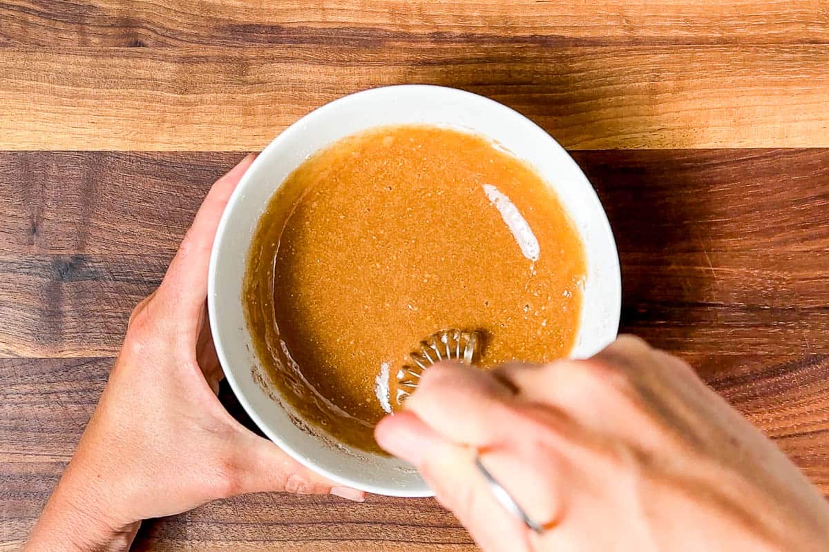 Mixing together the cornstarch with maple syrup and cinnamon.