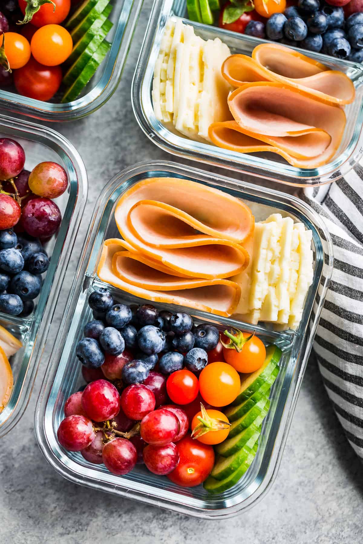 Close up view of Adult Lunchables in a glass meal prep container.