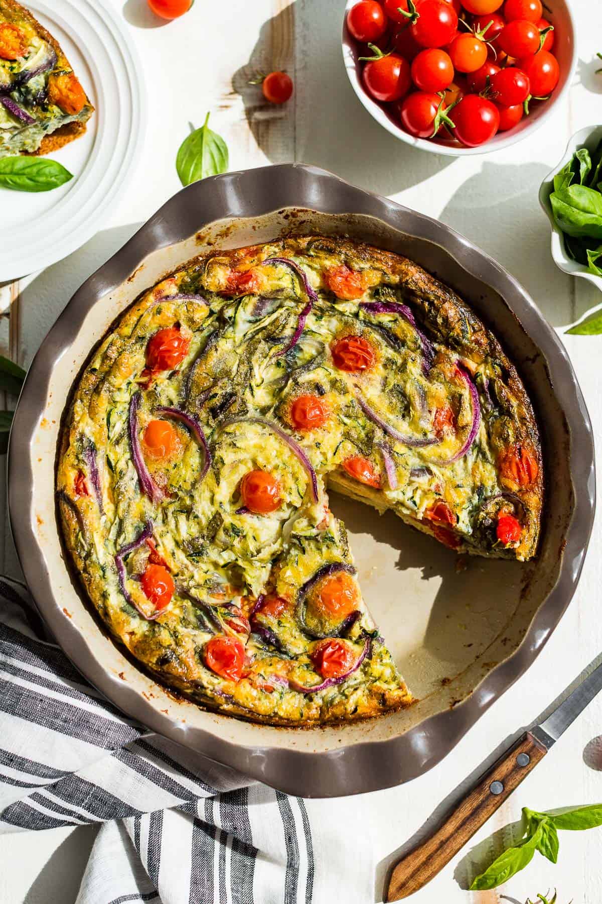 Straight down view of Vegetarian Breakfast Casserole in a pie plate with a slice taken out.