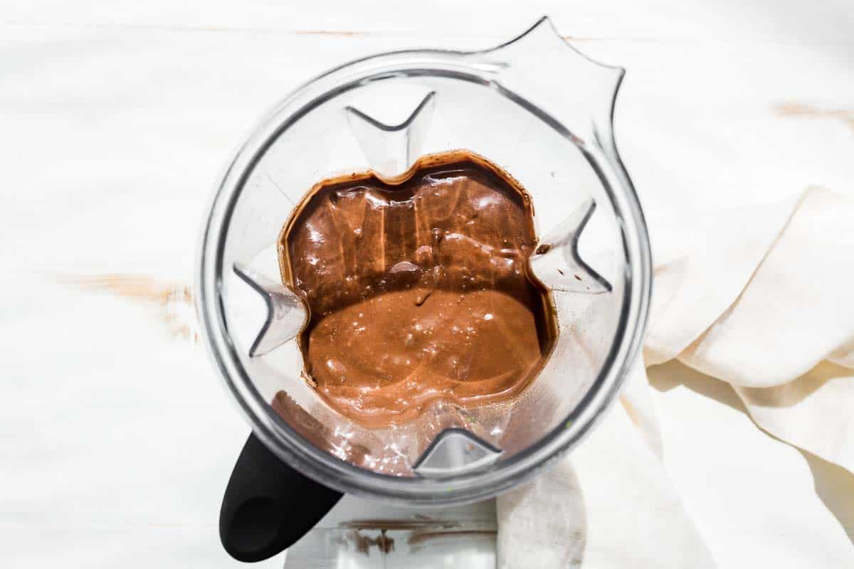 Blended chocolate avocado ice cream base in a blender container.