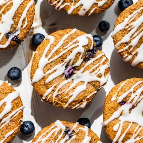 Glazed Paleo Blueberry Muffins on a white background.