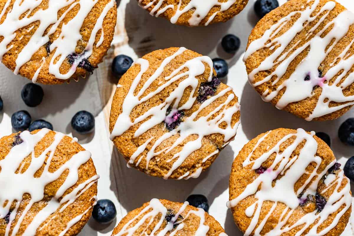 Glazed Paleo Blueberry Muffins on a white background.