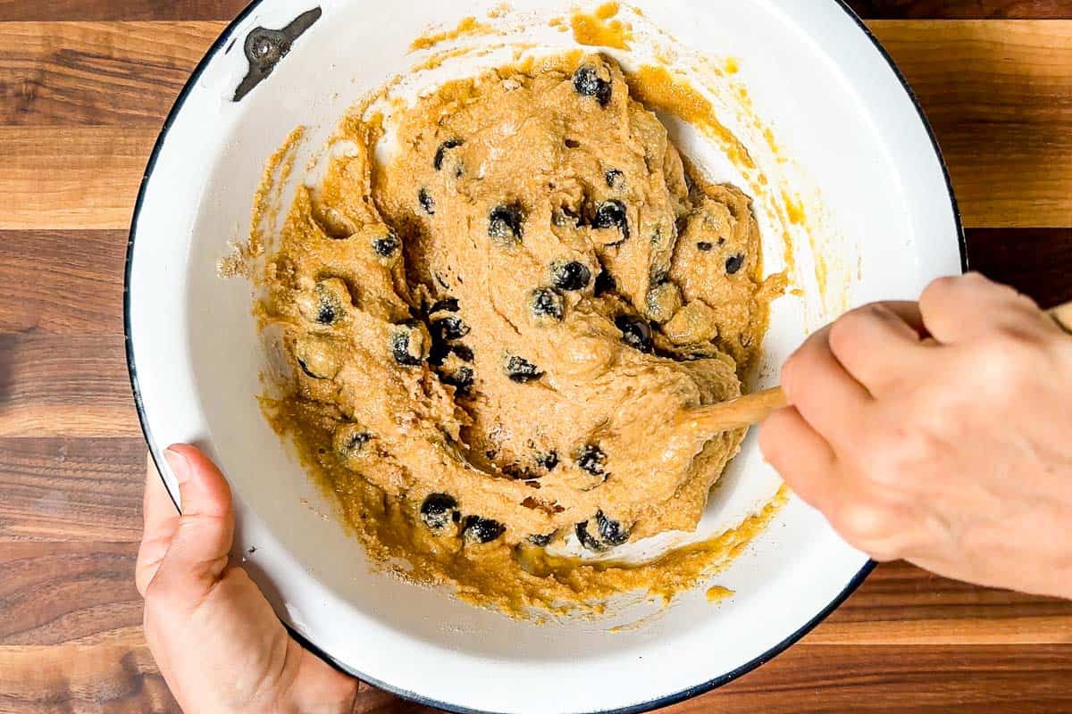 Mixed Paleo Blueberry Muffin batter in a white bowl.