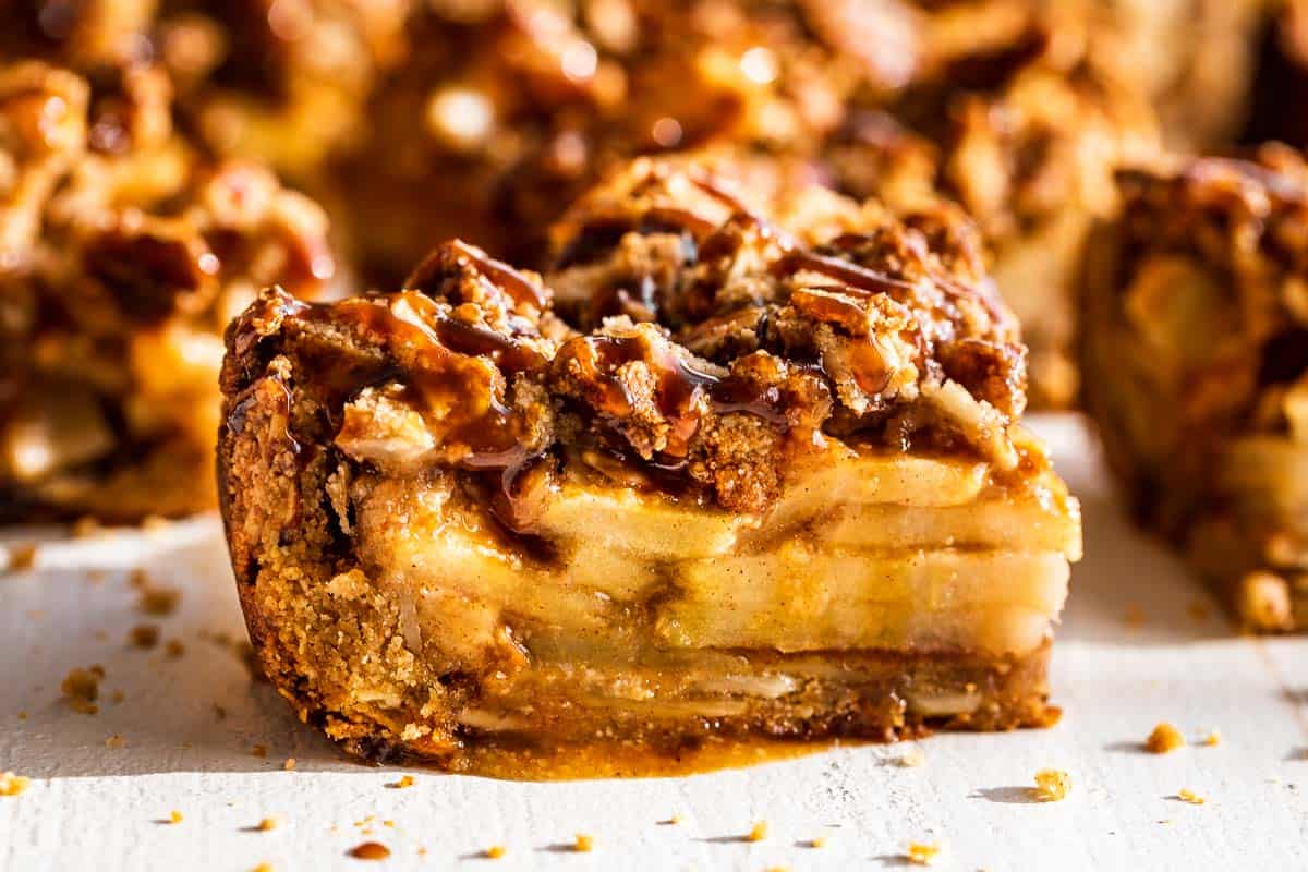 Very close view of a apple pie bar showing the apple filling and streusel topping.