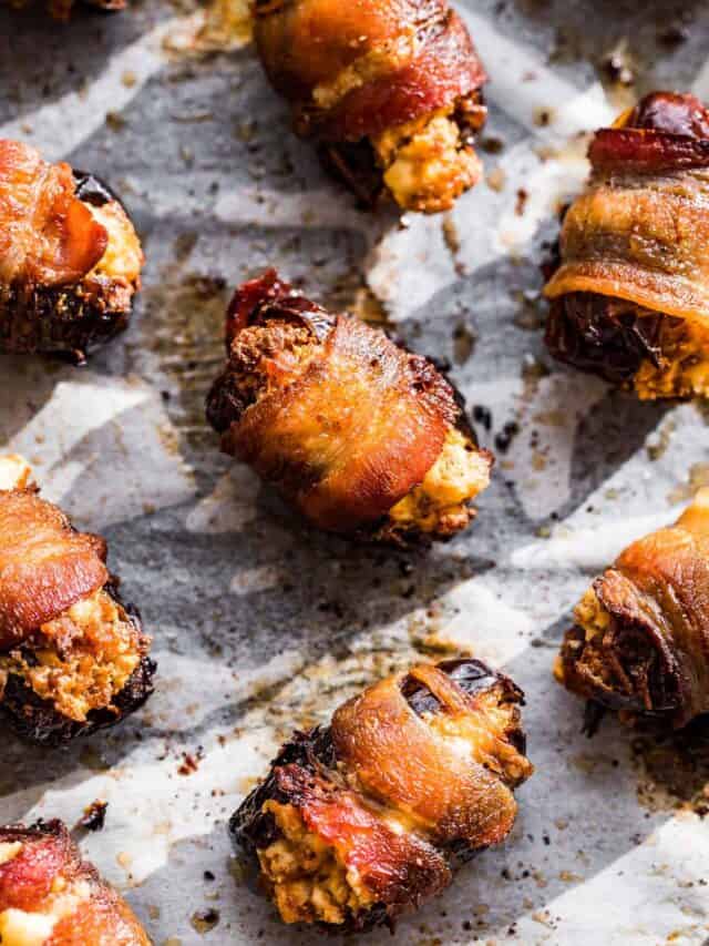 Bacon Wrapped Dates baked and crispy on parchment paper.