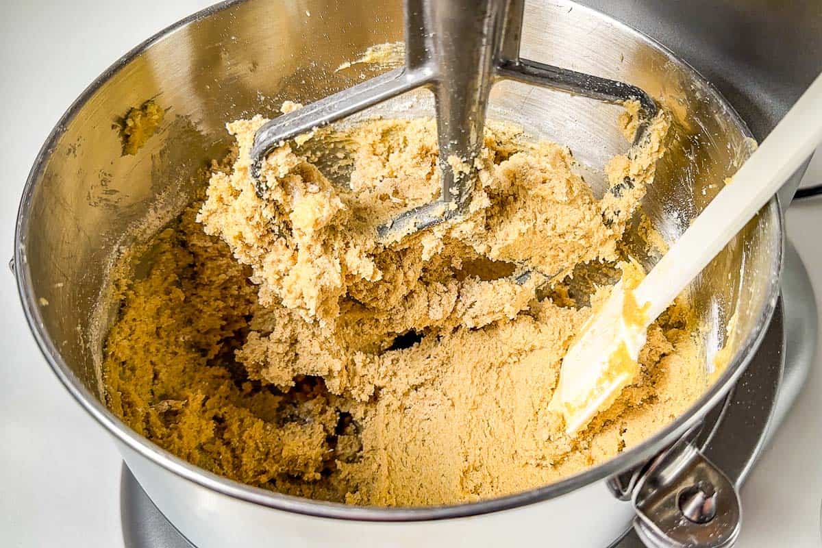 Adding the oat flour to the butter sugar mixture in an electric stand mixer.