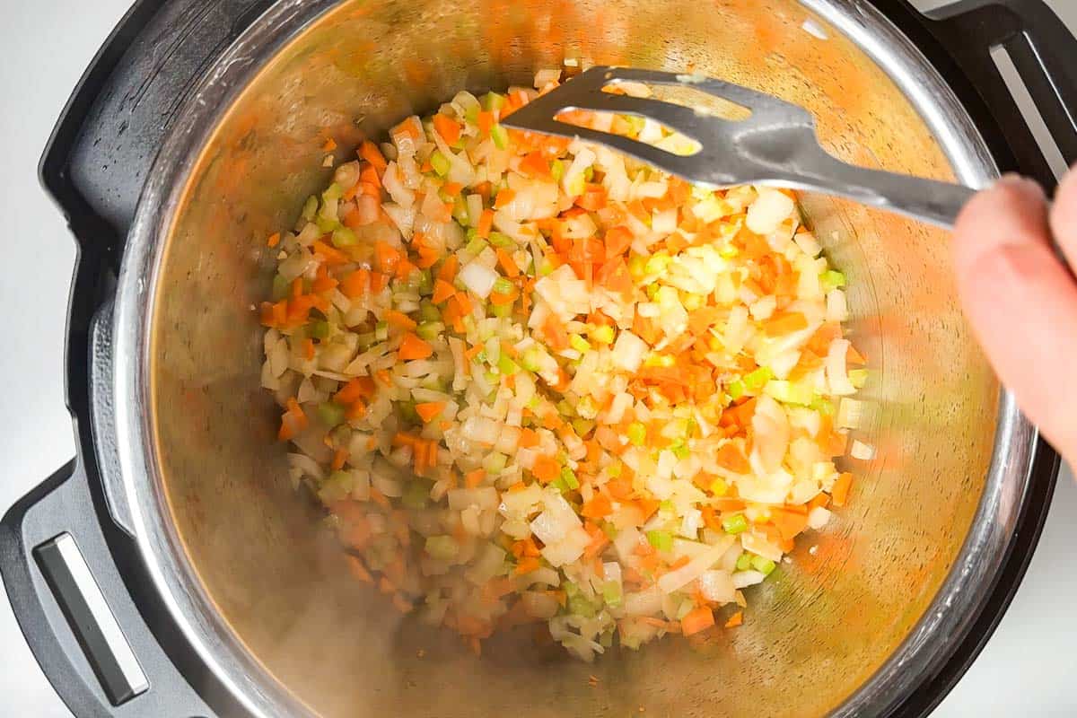 Cooking the onion, garlic, carrot, and celery in the Instant Pot.