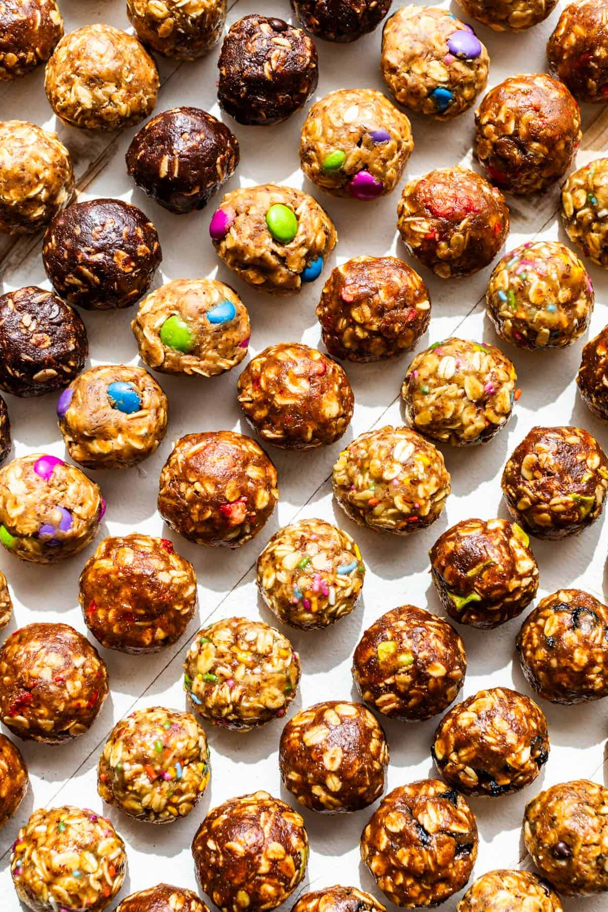 8 of the 10 Flavors of No Bake Energy Bites on a white background laid out in diagonal rows.