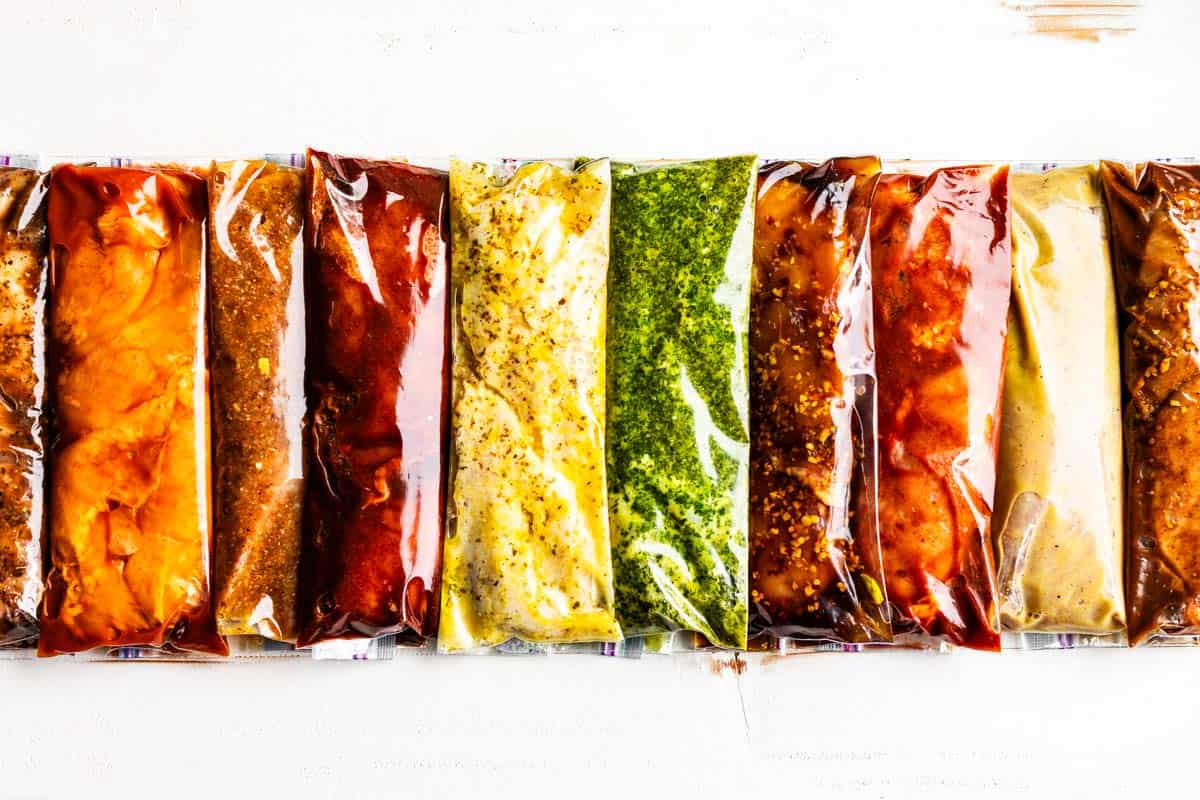 10 Best Chicken Marinades in plastic bags horizontally placed on a white background.