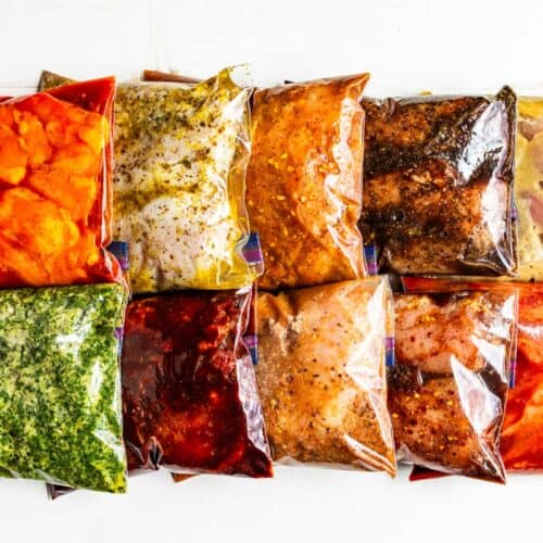 All ten chicken marinades in Ziplock bags arranged in two rows in a white background.