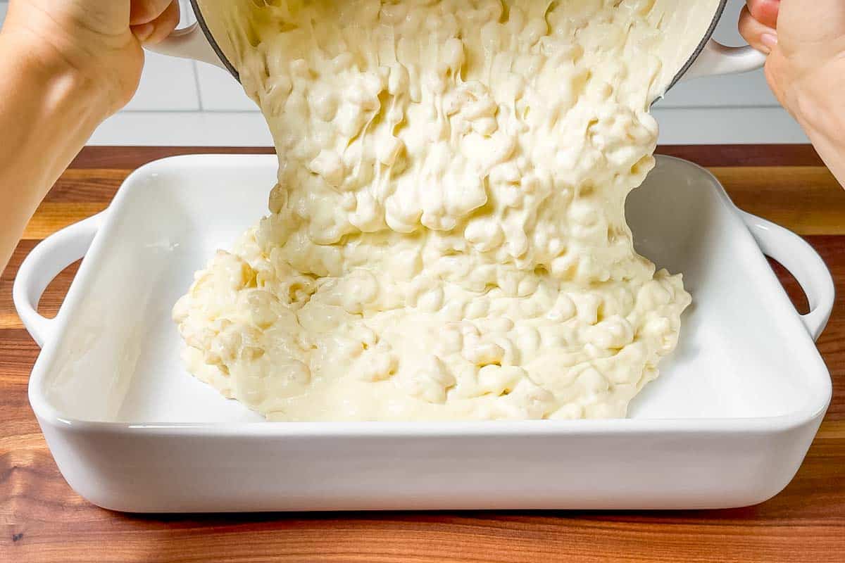 Pouring the macaroni mixture into a baking dish.