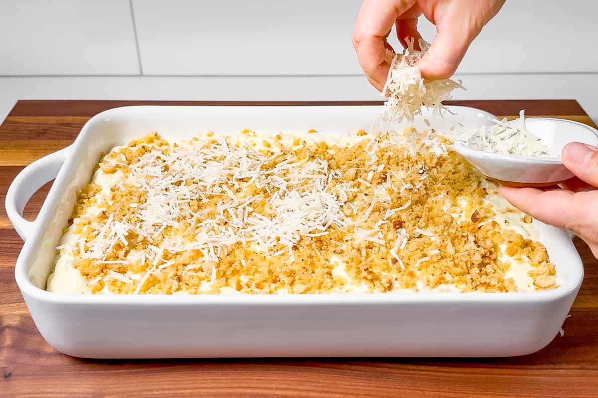 Adding the breadcrumb and parmesan to the top of the mac and cheese.