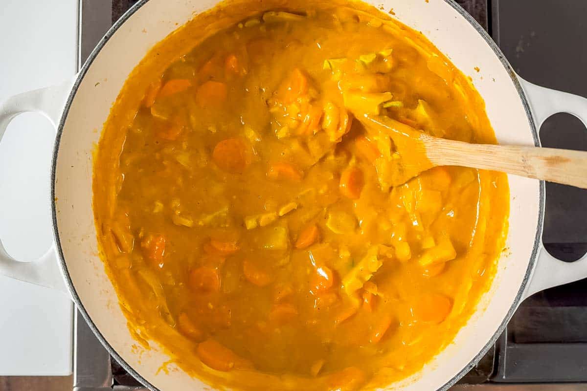 Simmering the veggies in coconut milk and pumpkin purée.