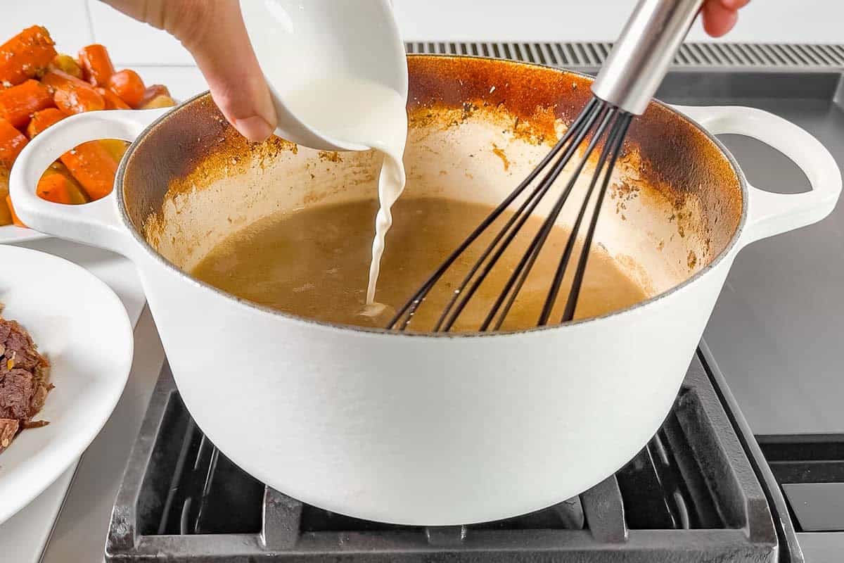 Making gravy from the pot roast juices in the Dutch oven with a cornstarch slurry.