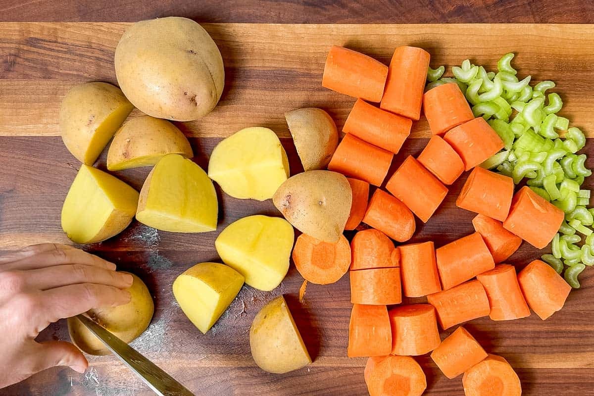 Cutting up Yukon gold potatoes, carrots, and celery.