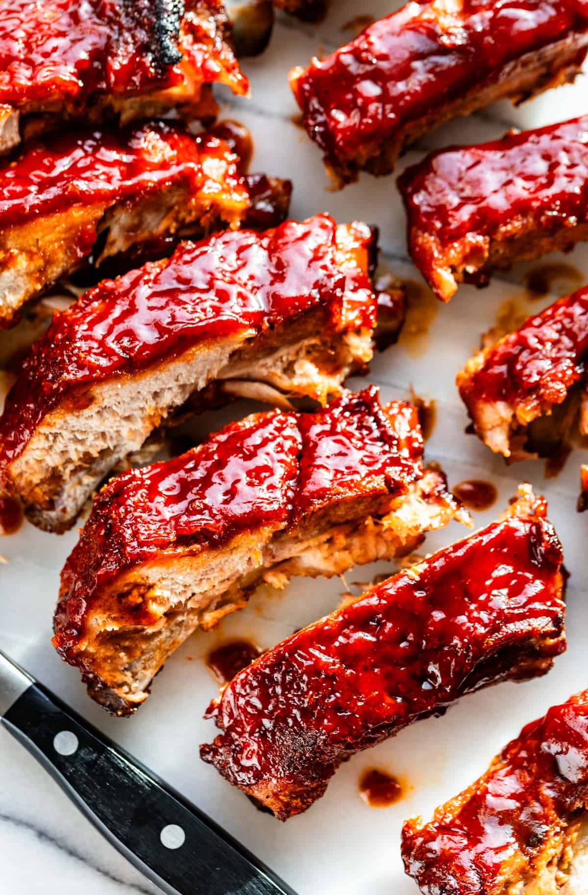 Baby back ribs glazed with bbq sauce and sliced.