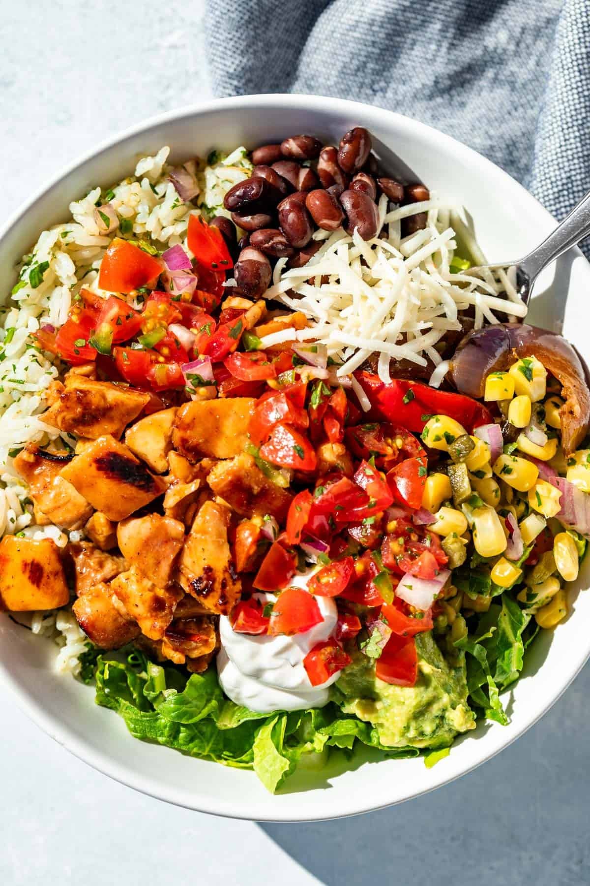 All the Chipotle meal prep ingredients made into a Chipotle Honey Chicken Burrito Bowl.