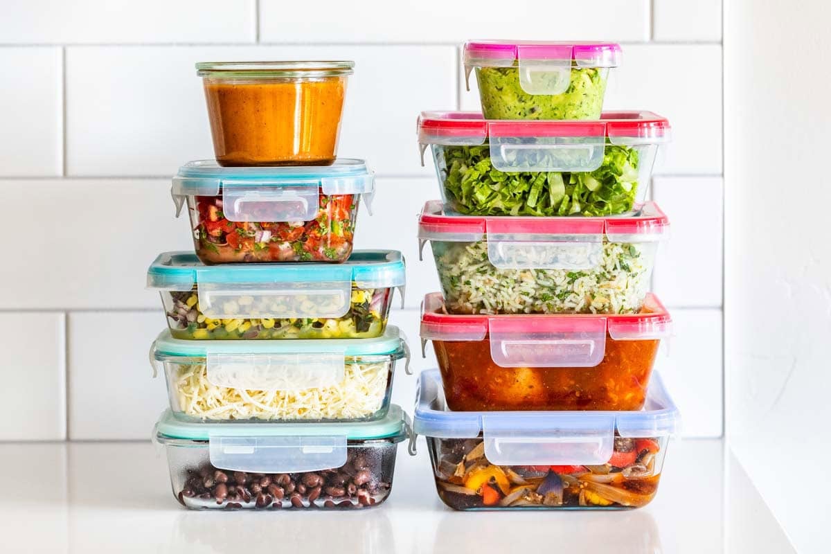 Containers of Chipotle Meal Prep stacked on a white countertop.