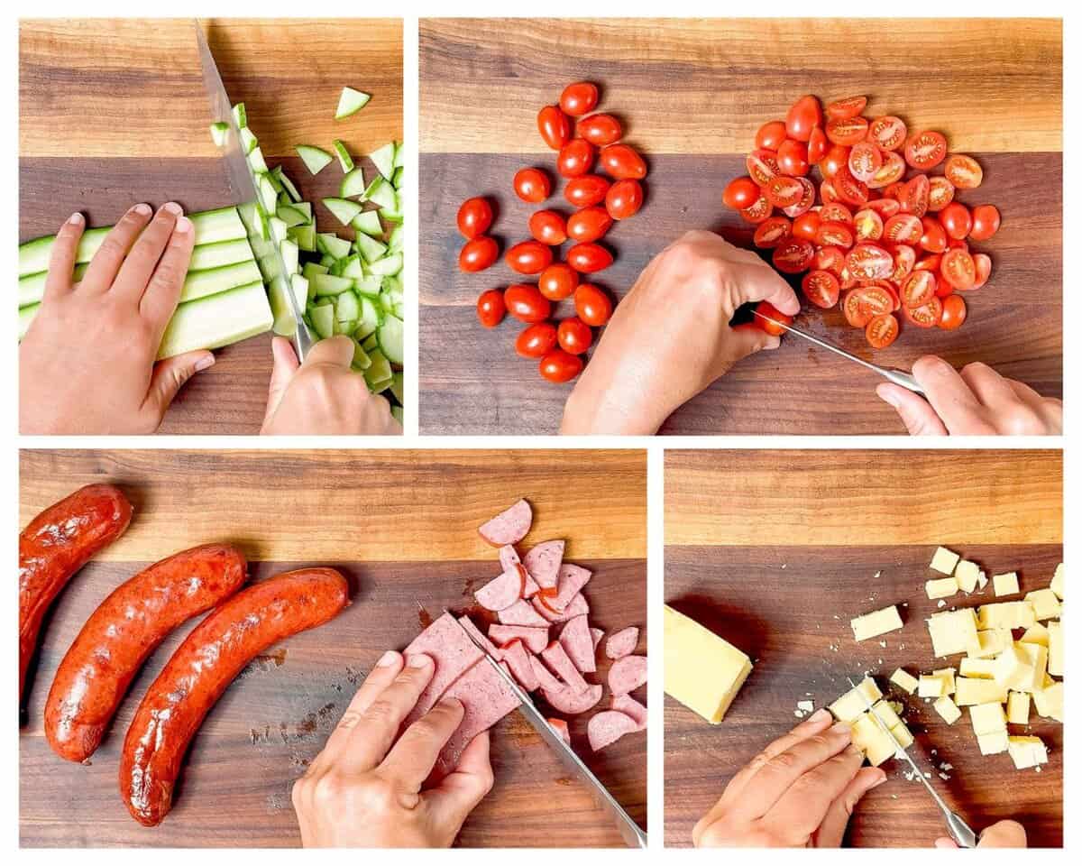 Four photos in a collage showing cutting up the cucumber, cherry tomatoes, cubed cheddar cheese, and sliced sausage on a wood cutting board.