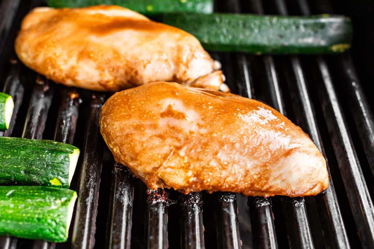 Balsamic marinated chicken on the grill with the zucchini.