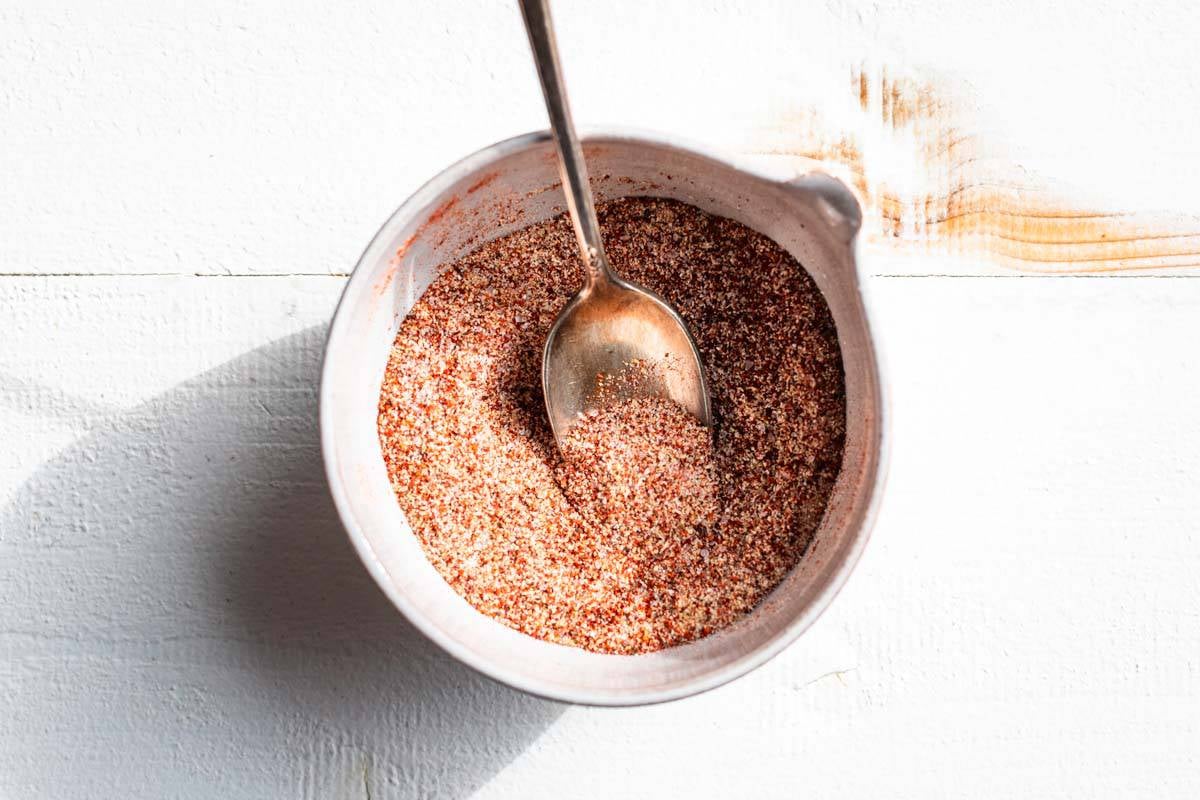 Spice mixture stirred together in a small pottery bowl.