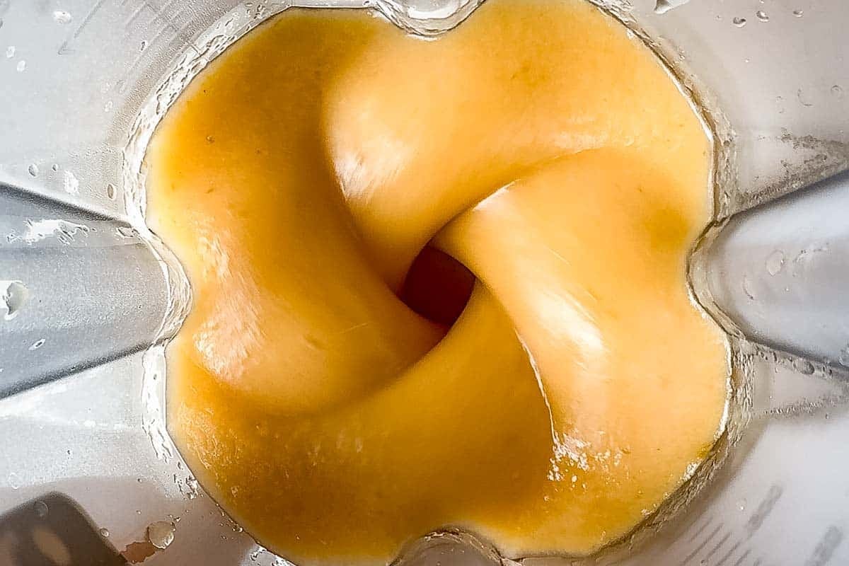 Blending the applesauce in a blender container.